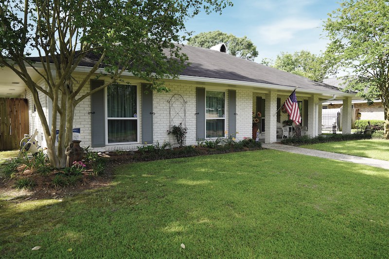 white brick house with replacement windows
