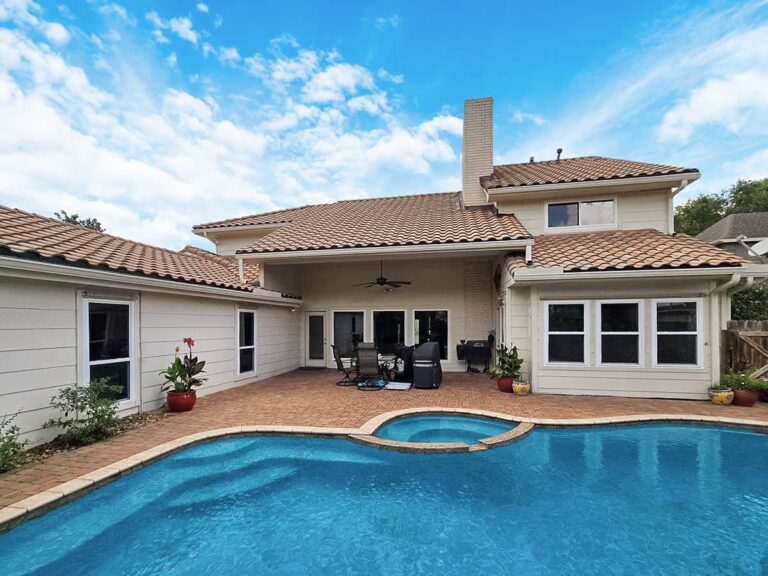 Backyard view with pool of house with windows